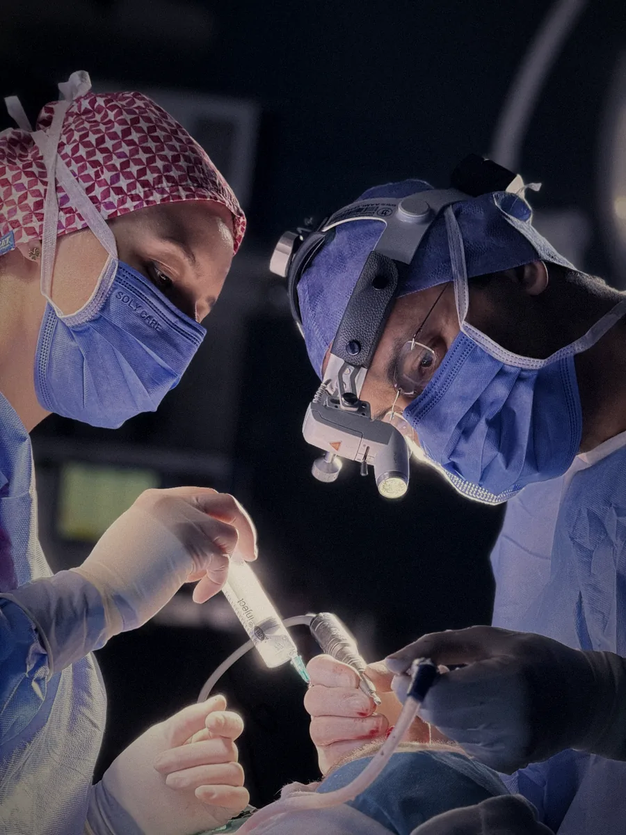 Surgeons at work under theatre lights